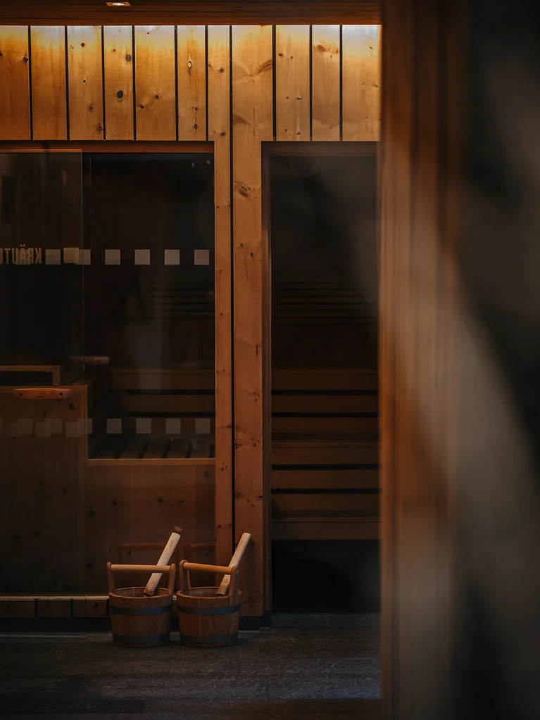 Inclusive services at Hotel Aurora in Lech Interior of a sauna with wooden walls and two wooden buckets